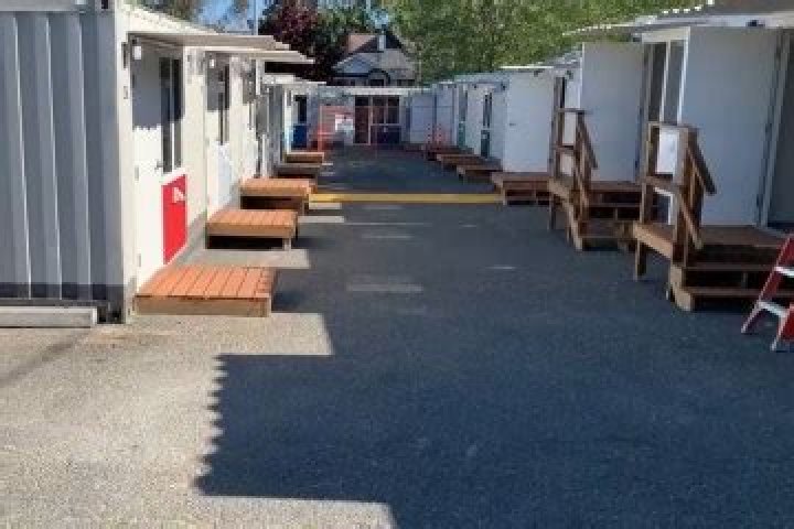 Inside a tiny home village where you don't have to pay, laundry is free but you have to meet the stay requirements