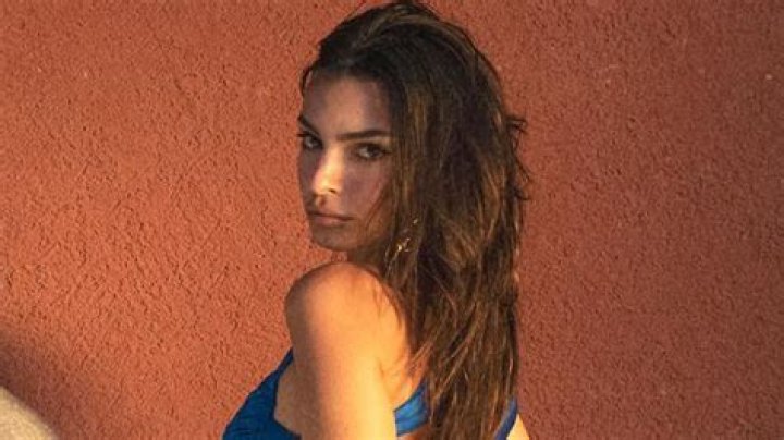 Emily Ratajkowski shows off her bare butt and six-pack abs in tiny satin blue bikini as she promotes Inamorata line