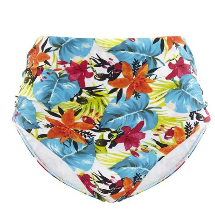 Halle Berry, 54, shows off toned figure in a white top and tropical-print bikini bottoms