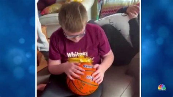 High school varsity basketball team surprises 10-year-old superfan on his birthday