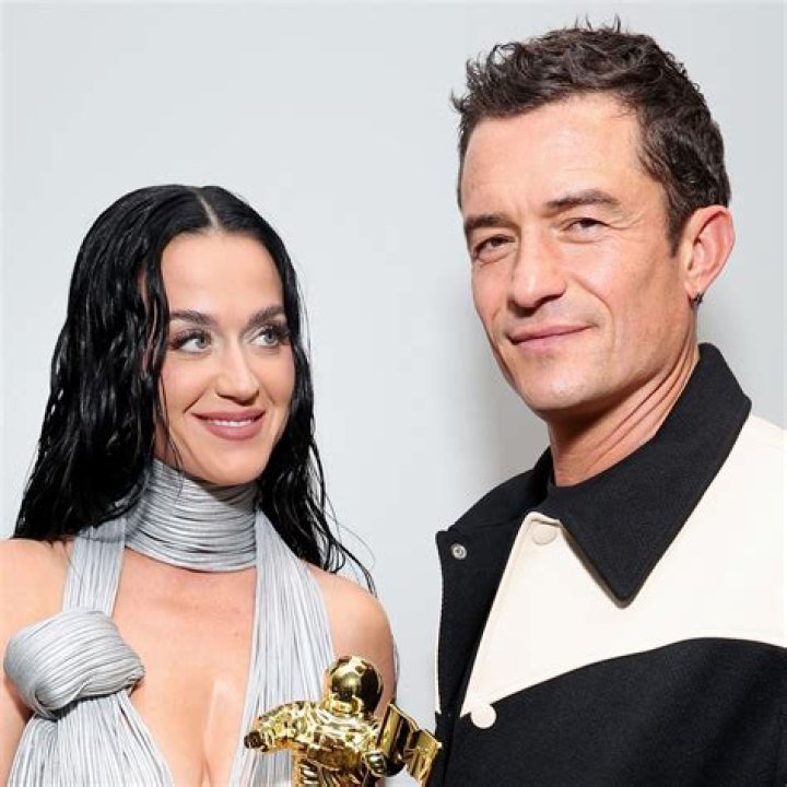 Katy Perry shows off curves in purple swimsuit as she holds baby Daisy, 6 months, and swims with shirtless Orlando Bloom