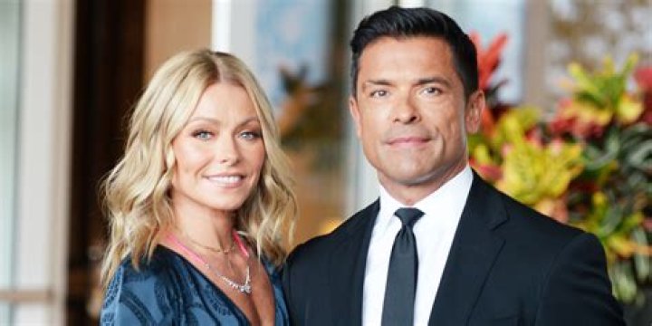 Kelly Ripa and husband Mark Consuelos wear thick wool trench coats and scarves in the sweltering NYC heat for new photos