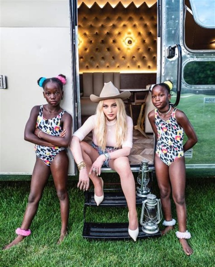 Madonna looks smokin’ as she boogies at family barbecue in hotpants and fishnets