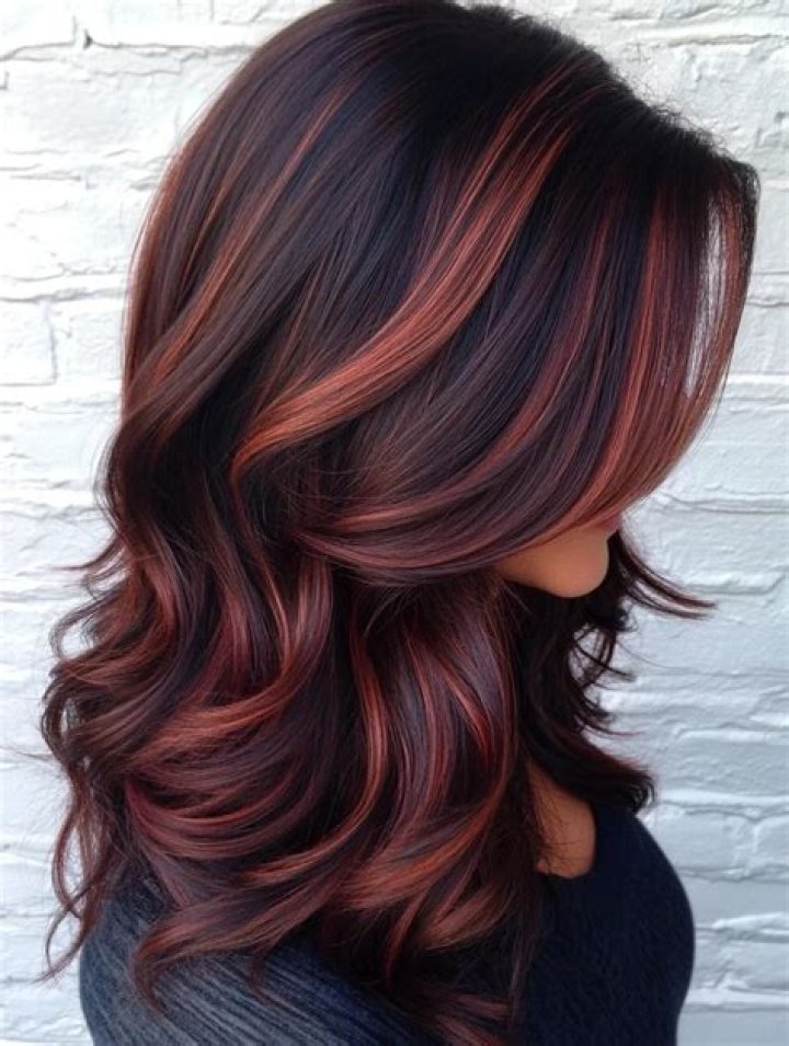 Embracing Boldness: The Allure Of Red Foils In Dark Brown Hair