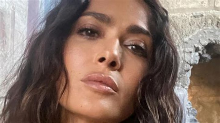Salma Hayek, 57, shows off age-defying curves in tiny black bikini on beach as fans say they're 'obsessed'