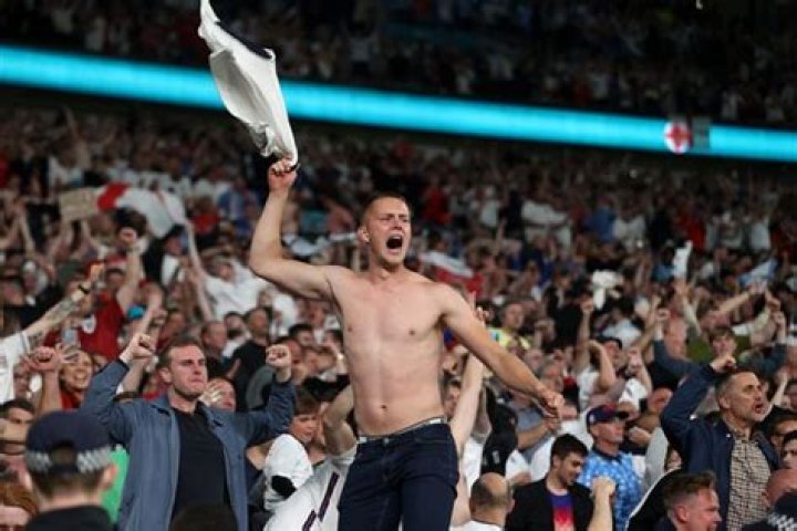 Hilarious moment shirtless England fan falls down seats in Wembley - then carries on celebrating