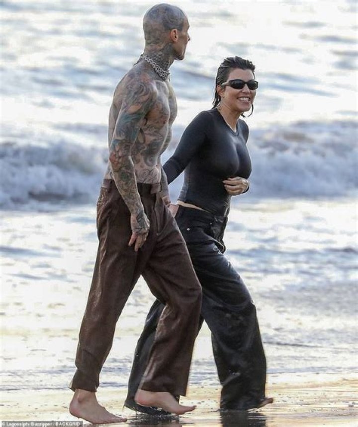 Travis Barker grabs Kourtney Kardashian's butt while she poses in thong bikini as rocker 'plans to marry the star'