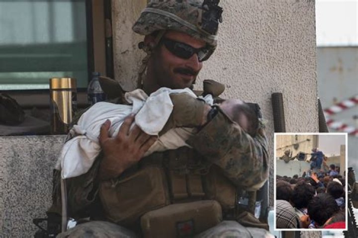 US Marines cradle babies in Afghan air lift to rescue 65,000 people in Kabul as Biden says people will die in evacuation