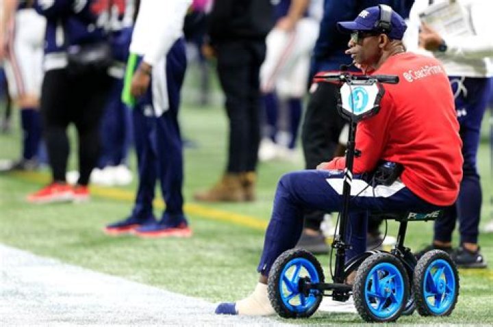 Why is Deion Sanders in a wheelchair?